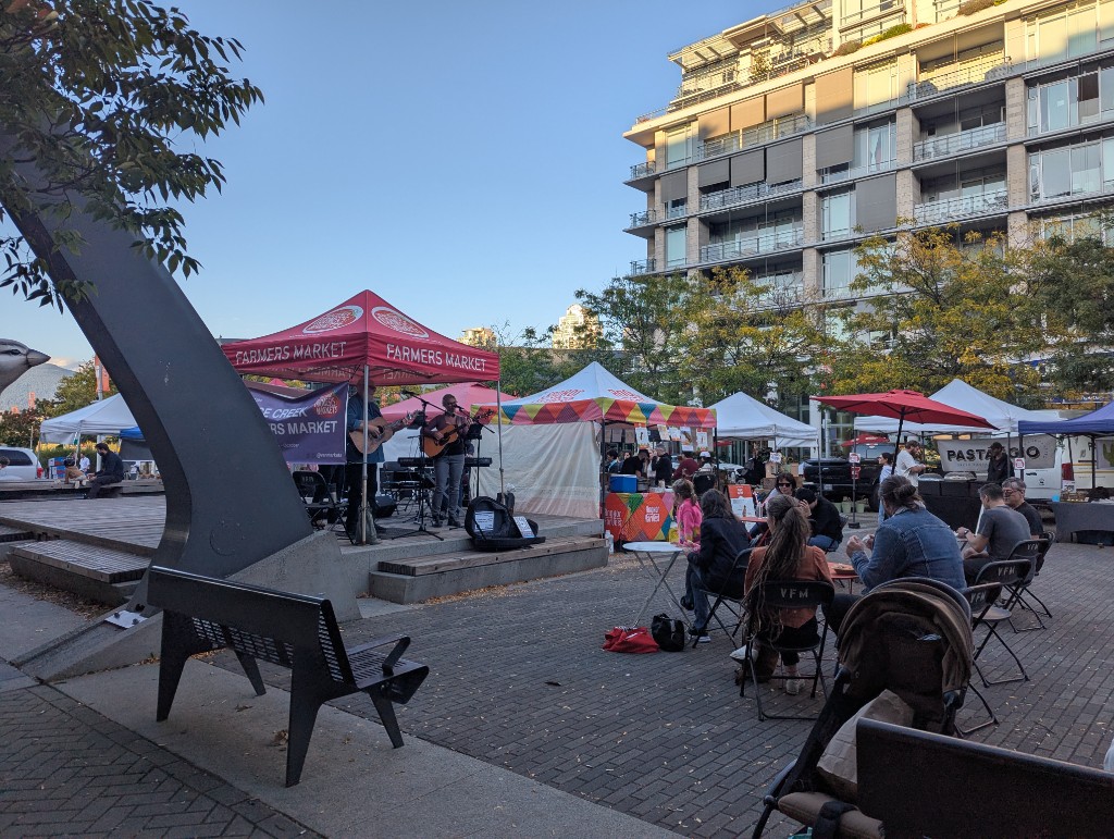 False Creek Farmers Market tents and stage at Milton Wong Plaza